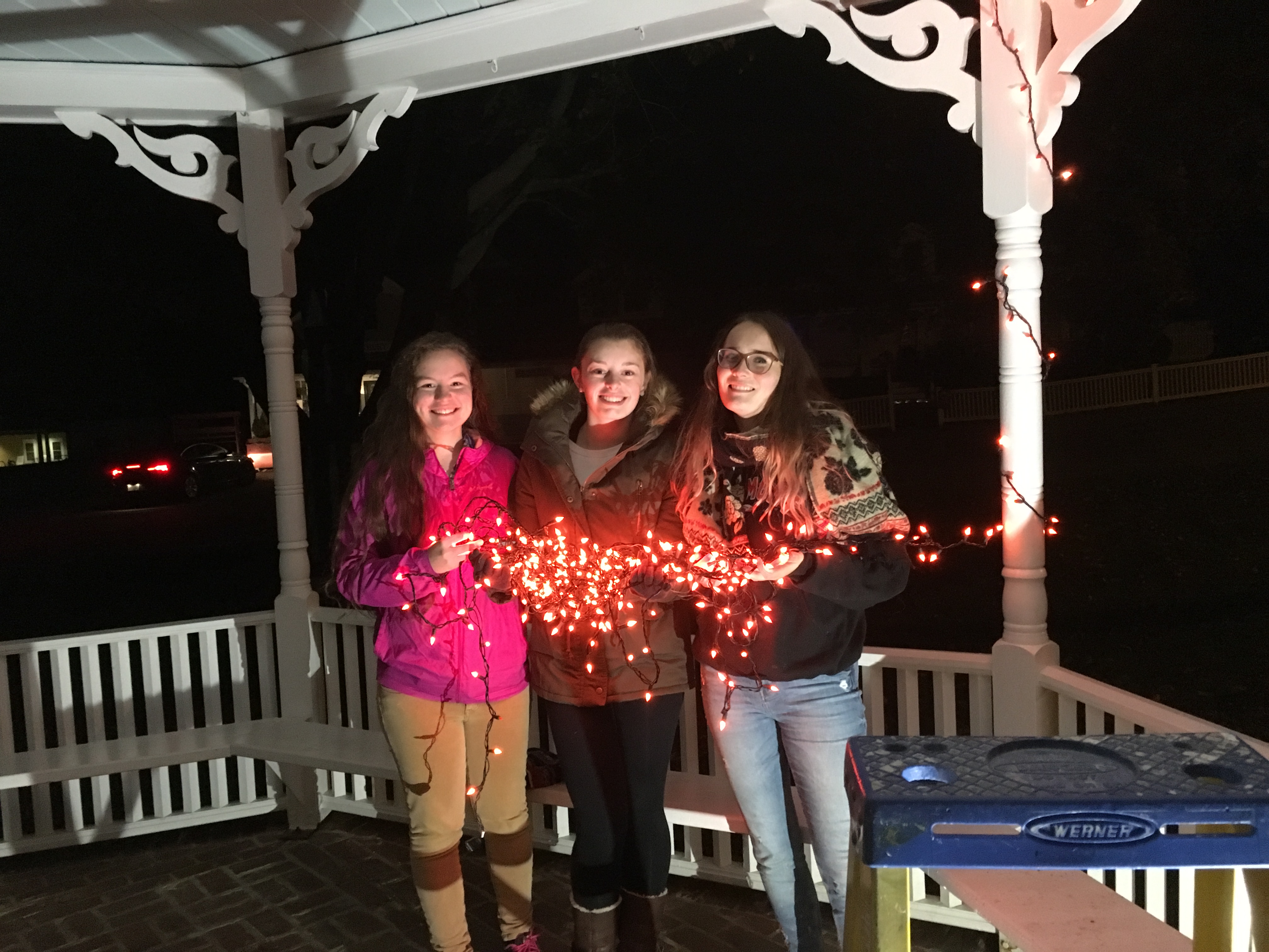 Youth Wrapping the Gazebo with Christmas Lighting